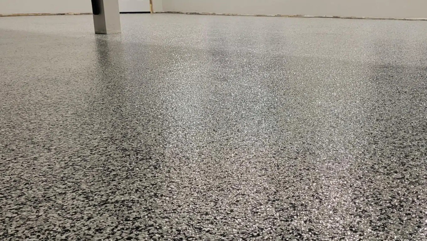 Smooth leveled epoxy-coated garage floor surface after concrete leveling service
