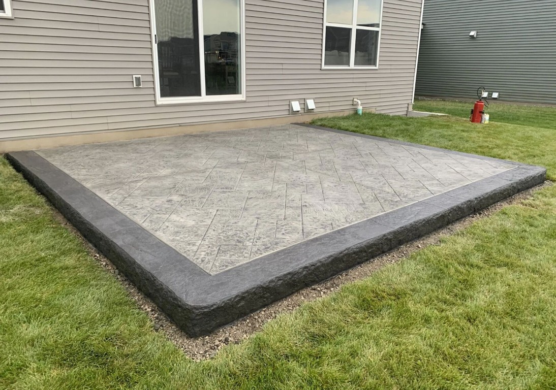 Decorative stamped concrete patio with bordered steps at a residential home